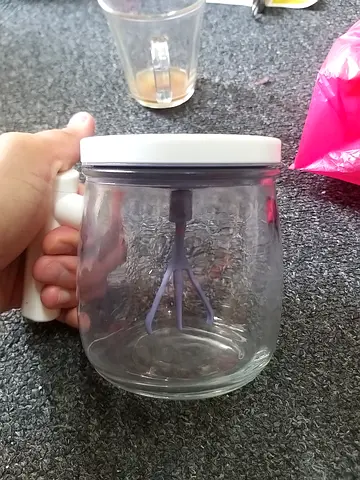 Glass jar with handheld milk frother - used