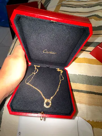 My gold circular pendant necklace with Cartier box
