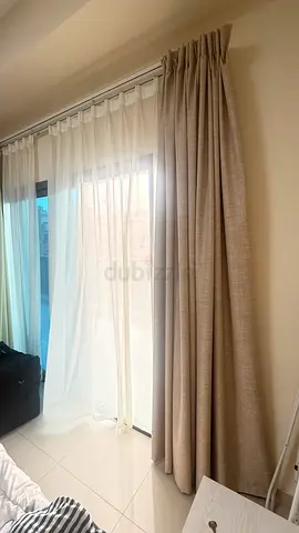 Heavy beige curtains with white sheer panels — used, good condition