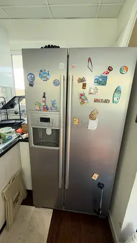 Side-by-side refrigerator with water  ice dispenser - used