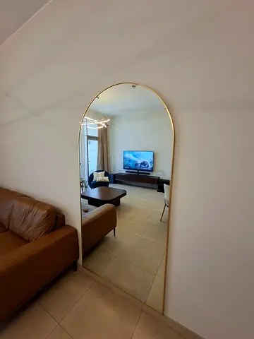 Large arched full-length mirror with gold frame