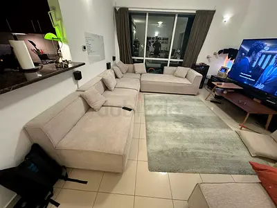 Beige L-shaped sectional sofa, good condition, can be made into U-shape, comes with ottoman