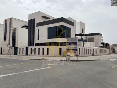 Villa for sale in Ajman, corner location, two floors and a roof terrace, at a bargain price including fees, registration and ownership. Excellent loca