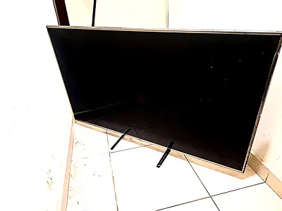 Used flat-panel LG smart TV with stand (SCREEN NOT WORKING)