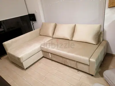 Beige L-shaped sofa bed with chaise and hidden storage - good condition