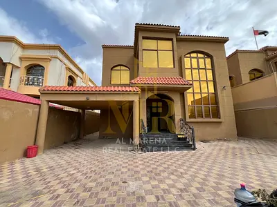 Luxury villa for sale in Al Muwaihat 1, Ajman, near Sheikh Ammar Street and Shurooq Mall. Price includes electricity, water, and air conditioning. The