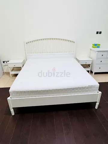 White double bed frame with mattress and 2 bedside tables
