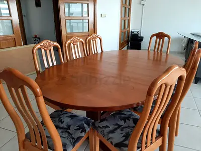 8-seater solid wood oval dining table with 8 chairs