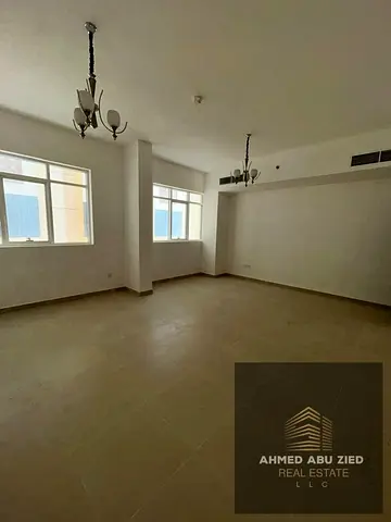 “Stylish luxury 2-bedroom apartment with spacious living room, equipped kitchen, 3 bathrooms, wall cabinets, near Sheikh Zayed Rd, full maintenance by