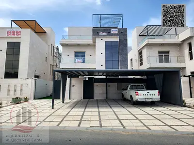 Villa for sale in Ajman, Al Zahia area, including registration, 5 master bedrooms, majlis, living room, roof terrace, and maid's room.