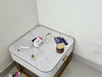 Marble-top nightstand with gold frame and drawer