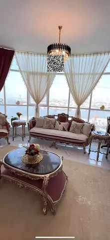 For sale in Ajman, two bedrooms and a living room in Al Waha Tower at an excellent price with amenities including gym, swimming pool, and parking.