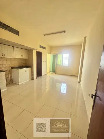 Studio for annual rent with balcony and central AC in Al Rawda 1 – close to Dubai exit and Al Hamidiya Police Station.