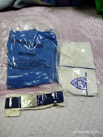 Kids school uniform set — white shirt with crest, blue pants and belt (new, packaged)