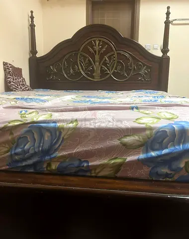 Carved solid wood bed frame with decorative headboard