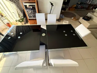 Modern black glass dining table with 6 white chairs
