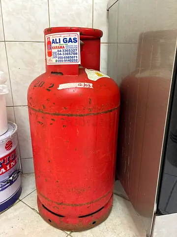 Used red LPG gas cylinder and regulator.