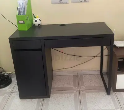 My black compact computer desk .