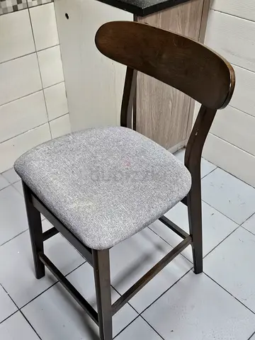 Wooden dining chair with grey upholstered seat