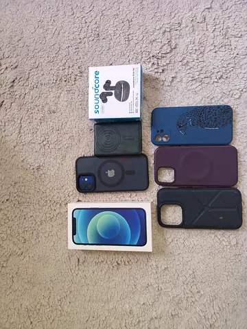 Apple iPhone (blue) with green leather wallet card case  with Soundcore headset - boxed