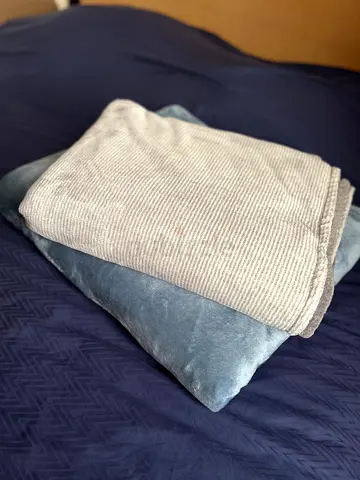 Light grey ribbed throw with blue velvet cushion - good condition