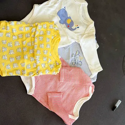 Selling 3 long-sleeve baby onesies (mixed prints), gently used