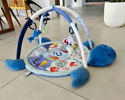 Soft baby play gym activity mat with hanging toys - gently used