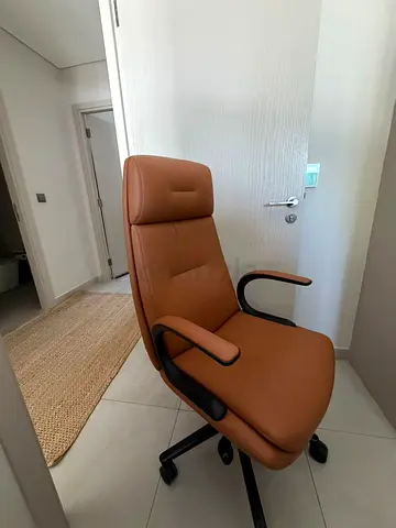Brown leather ergonomic office chair with headrest