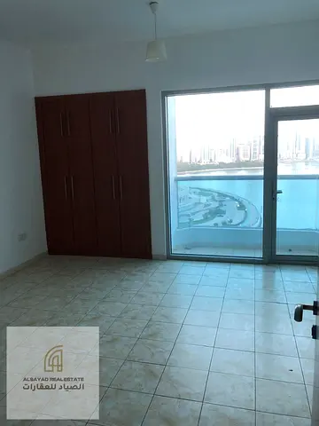 Apartment for sale in Al Majaz 3 with an open view of Al Majaz Amphitheatre, consisting of two bedrooms and a very distinctive living room, ready to m