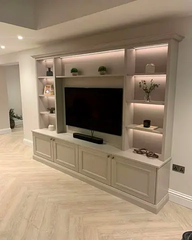built-in TV unit with LED-lit shelves and storage