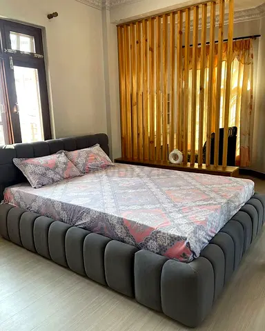 My grey upholstered platform bed frame — modern low-profile