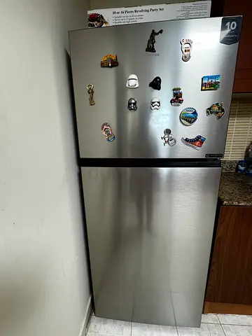 Move Out sale- My stainless steel refrigerator with top freezer with 1 year extended warranty