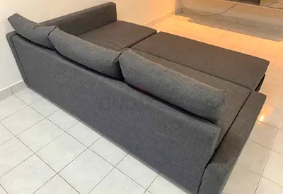 My grey fabric sofa that converts into a bed — good condition