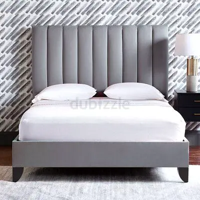 Grey upholstered bed frame with tall vertical channel headboard