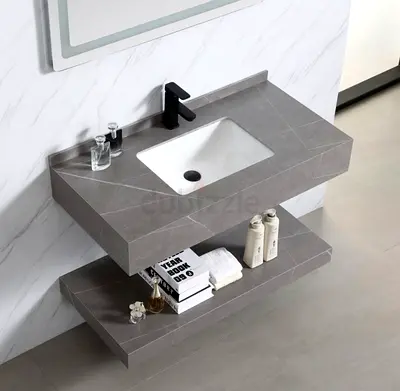 Wall-mounted grey stone-effect vanity with integrated sink and open shelf