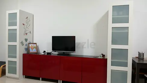 Red glossy TV cabinet with two tall white display cabinets
