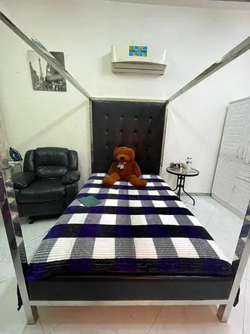 Metal four-poster bed with mattress in a good condition for sale