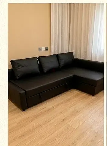 Black L-shaped sofa with storage - Good condition