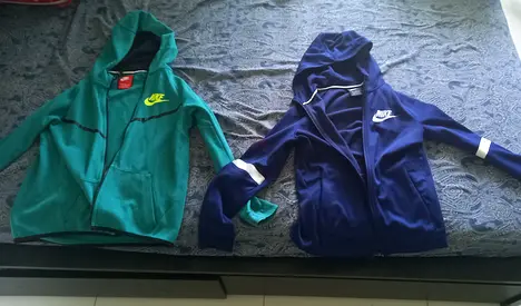 Im selling two Nike zip-up hoodies (green  navy) - good condition