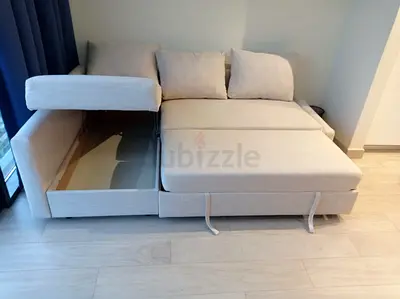 My beige convertible sofa bed with storage — excellent condition