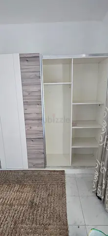 White sliding wardrobe with shelves and hanging rail
