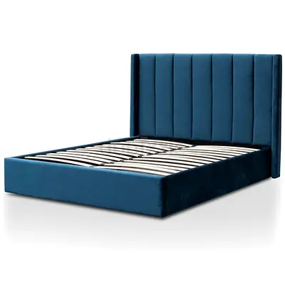 Blue velvet platform bed with tall channel headboard