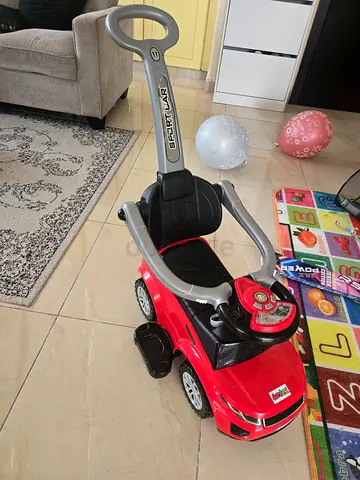 Red toddler push ride-on car with parental handle - used