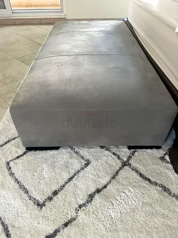 Gray upholstered ottoman/footstool - good used condition