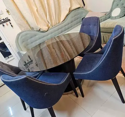 Round 4-seater dining set with glass top and upholstered chairs
