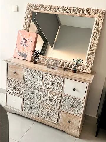 wooden dresser with matching carved-frame mirror