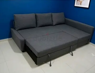 My grey L-shaped sofa bed with pull-out — good condition