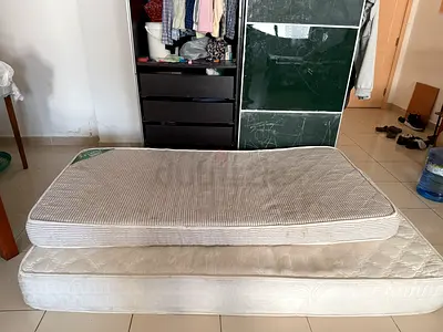 Two single mattresses (base mattress + thin topper) — used