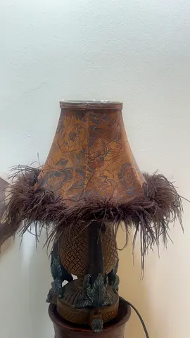 Carved decorative table lamp with feather-trim shade