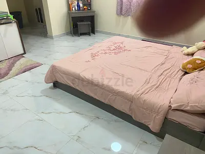 King Size wooden bed with mattress and pink bedding